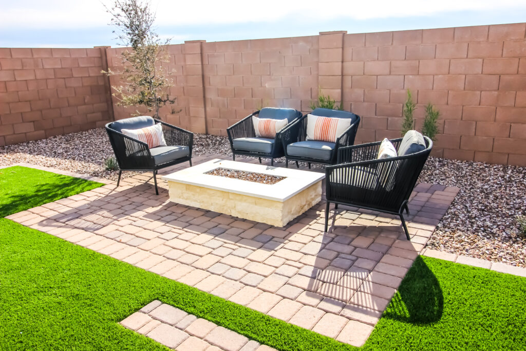 Rear Yard Conversation Area With Four Wicker Chairs On Pavers Patio