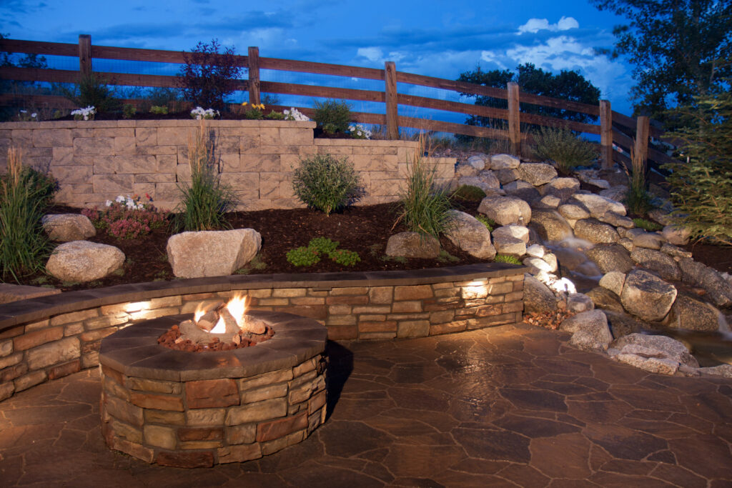 An amazing and beautiful backyard fire pit, seat wall and water feature. Inspiring ideas for backyards